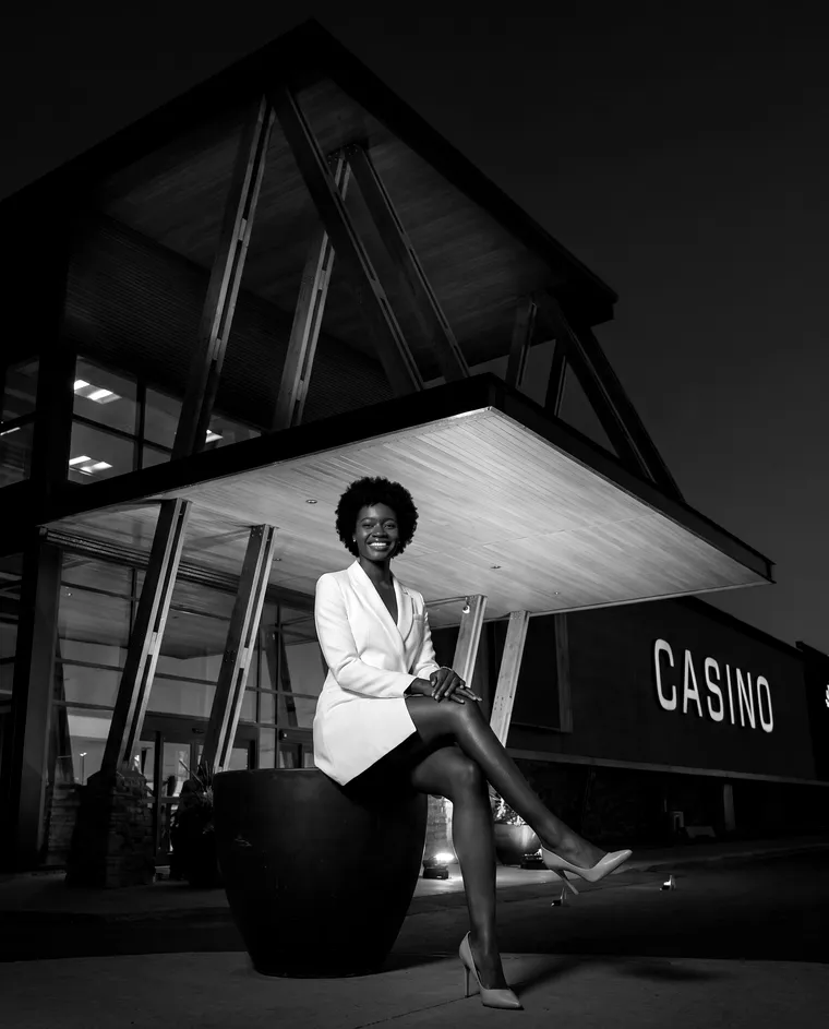 A woman at the Gold Horse entrance at night
