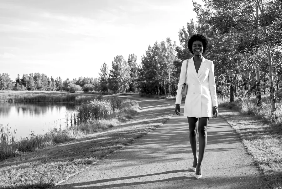Woman walking a park trail by a pond